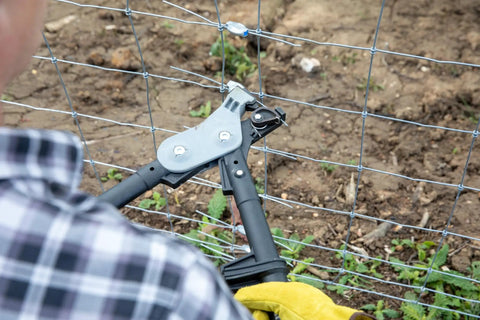 Easy Fencing Wire Joiner Medium Gauge 10 To 13.5 being used to join and tension wire on a farm fence