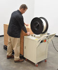 Heavy Duty Semi Automatic Pallet Strapping Machine Steel Probe Frame 23 X 31.5 X 55 Inches in use for sealing boxes.