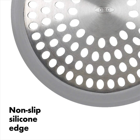 Close-up of stainless steel bathtub drain protector with hair catcher, non-slip silicone edge for quick clog prevention.