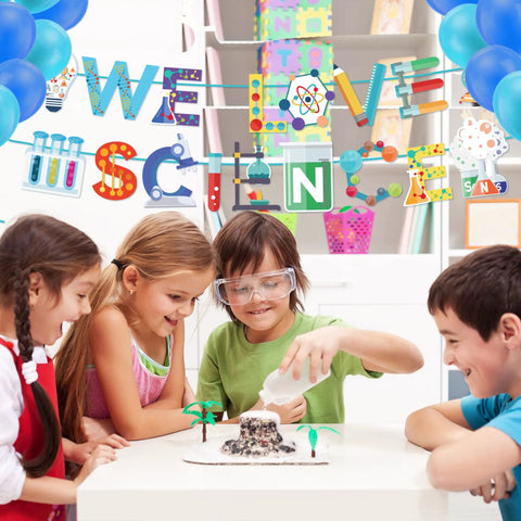 Epic We Love Science Banner Set for Mad Science Party Decorations in classroom with kids performing science experiment.