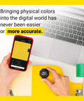 Person using Portable Color Sensor And Color Matcher Tool With 300000 Plus Paint Library with smartphone and laptop