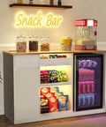 Snack Bar Cabinet With Fridge Space And Candy Display Shelf, All In One Coffee Station For Home Theater Or Game Room, White 51.2 Inch Long Storage Organizer for chips, cookies, and candy with neon sign and popcorn machine.