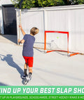 Child playing with Street Hockey Set With Pop Up Goal Two Wooden Hockey Sticks With Plastic Heads And Two Street Hockey Balls