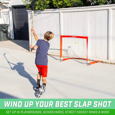 Child playing with Street Hockey Set With Pop Up Goal Two Wooden Hockey Sticks With Plastic Heads And Two Street Hockey Balls