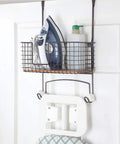 Metal Over The Door Or Wall Mount Ironing Board Holder With Large Storage Basket, ironing supplies and board shown.