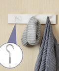 Ten Pack Tough As Nails 304 Stainless Steel Screw Eye Hooks Two Point Five Inch Heavy Duty self tapping ring holding a gray mitt.