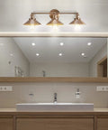 Bathroom featuring Brass Gold 3 Light Industrial Farmhouse Vanity Wall Sconce With Metal Shade For Bathroom Kitchen And Entryway Modern Sleek Dope Illumination With LED Bulbs Included Perfect Mirror Light above mirror