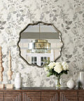 Breezy Peel And Stick Botanical Wallpaper In Gray behind round mirror and floral decor, removable self adhesive wall covering for easy install.