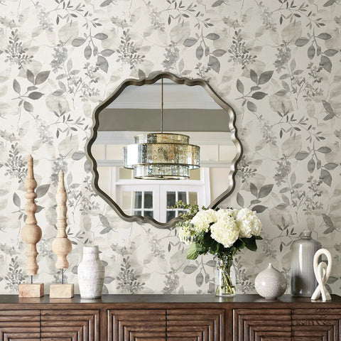 Breezy Peel And Stick Botanical Wallpaper In Gray behind round mirror and floral decor, removable self adhesive wall covering for easy install.