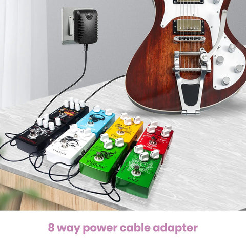Guitar Pedal Power Supply 9V 1A DC Center Negative For Multi Pedal Boards, 100-240V AC Input powering multiple pedals and guitar.