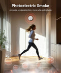Dead Set Reliable Smoke Detector Featuring A Built In Ten Year Battery For Zero Stress Home Safety And Hassle Free Protection Keeping Families Secure Indoors mounted on wall with a person running under it.