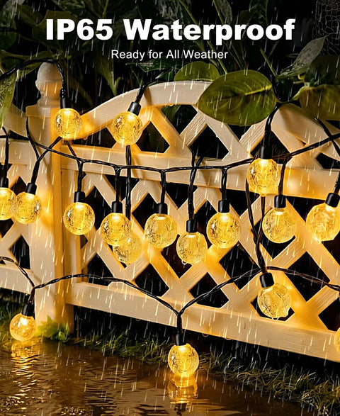 Two Pack Outdoor Solar String Lights Waterproof 98 Feet Total 100 LED Solar Powered Patio Lighting glowing on fence