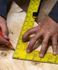 Hands using Beefy Brass Stair Gauge Set For Framing And Carpentry Squares 2-Piece for precise right-angle cuts on wood