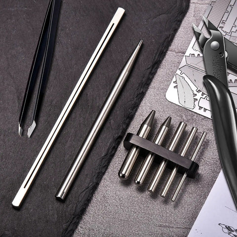 12 Piece Metal Model Tool Set For DIY 3D Puzzles Includes Long Edge Bending Tools Tab Twisting Tool Cone Bend Aids Clipper And Four Metal Tweezers For Precise Assembly displayed on slate with close-up of tools.