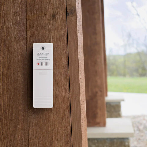 Wireless Outdoor Temperature and Humidity Sensor With Wall Mount Weather Resistant Gauge installed on wooden exterior surface
