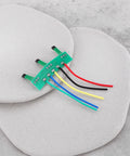 Four Pack Hall Sensor Pcb Board 41F Nifty Swap For Brushless Hub Motors on smooth stones with wires in various colors.