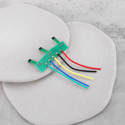 Four Pack Hall Sensor Pcb Board 41F Nifty Swap For Brushless Hub Motors on smooth stones with wires in various colors.