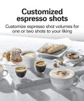 Customized espresso shots displayed with pastries on a marble tray, showcasing the Kickstart Your Morning Grind With This Retro White Espresso Machine Highlighting A Patent Slide And Lock Portafilter 15 Bar Pressure And A Hit Different Milk Frother For Silky Lattes And Bold Cappuccinos Pure Barista Vibes Guaranteed.