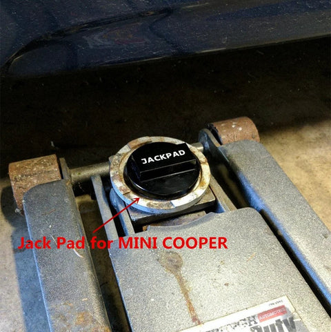 Black anodized jack pad adapter cap labeled JACKPAD installed in a car jack base