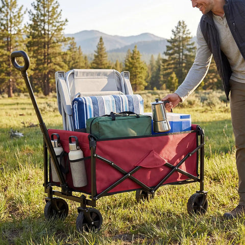 Collapsible Wagon Cart With 67L Storage And 220 Lb Weight Capacity Heavy Duty Folding Utility Wagon On Wheels For Beach Grocery Runs Camping And Garden Red carrying camping gear in a field.
