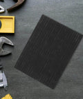 Heavy Duty High Purity Graphite Pad Plate 200 By 150 By 2.5 Mm next to tools on a workbench.