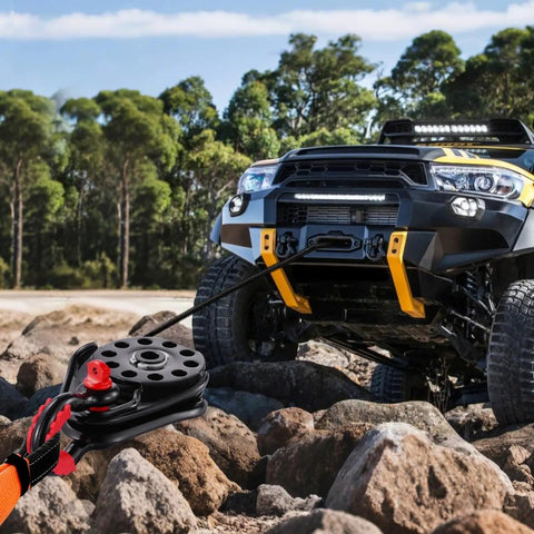 Heavy Duty 14.5 Ton Snatch Block For Winch Recovery With 32,000 Lbs Break Strength being used on an offroad vehicle