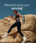 Woman climbing rocky terrain holding a water bottle featuring Straight Up Liquid Trace Mineral Drops Loaded With Seventy Plus Ionic Minerals And Key Electrolytes Like Magnesium Potassium And Chloride For Prime Body Function And Real Daily Vitality.