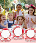 100 Count 7 Inch Red And White Checkered Paper Plates For Parties at a birthday celebration with kids smiling around a cake.
