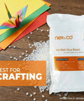 Straight Up General Purpose Hot Melt Glue Beads For Crafting 1 Pound Bag on wooden surface with colorful paper and origami crane.