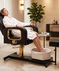Pro Grade Hydraulic Pedicure Station For Nail Techs With Roomy Removable Foot Tub Featuring Triple Vibration Soaking Modes For Zero Hassle Plug And Play Setup Without Any Plumbing Required In Sleek Black Finish with client relaxing.