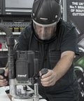 Badass Powered Air Respirator And Hearing Protection Bundle For Woodworking Shops Featuring Full Face Impact Shield Heavy Duty Dust Filters And Integrated Ear Guards Built Tough For Sanding Routing And Turning in use on router machine.
