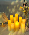 Flameless Battery Operated LED Pillar Candles Set Of Nine With Remote And 24 Hour Timer Ivory Real Wax Look on table