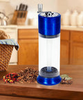 Do It All Three In One Spice Grinder With Hand Crank, roller crusher, blue aluminum body, and clear viewing chamber on kitchen counter