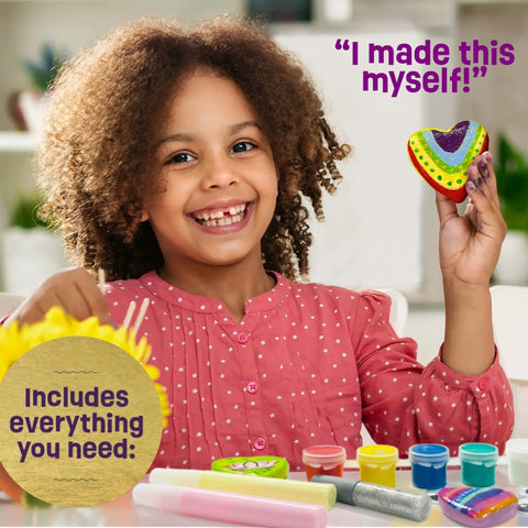 Girl holding a painted heart rock with glow paints from Glow In The Dark Heart Rock Painting Kit For Kids Ages 4 To 12