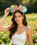 Woman outdoors wearing Blue Balloon Hut Sequin Ears Headband With Cloud Confetti Bow And Balloon House Charms Fun Plush Mouse Ear Accessory For Adults And All Your Outings Cute Day Trip Party Wear For All Day Adventures