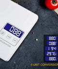 Digital Kitchen Scale 33Lb Capacity With High Precision Sensors Tare And Unit Conversion LCD Display A Must Have For Baking Cooking And Meal Prep Easy Read White Finish on grey surface with red tomato in view