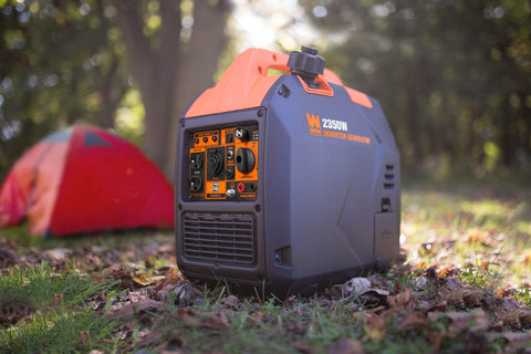 Ultra Quiet 2350 Watt Portable Inverter Generator With Fuel Shutoff in woodland campsite next to a red tent