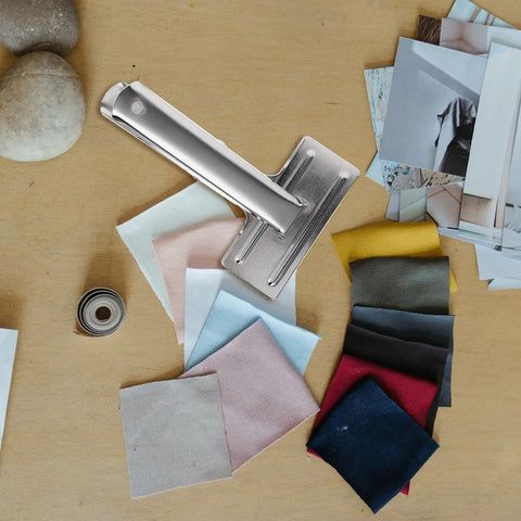 Heavy Duty Metal Sewing Bed Cloth Clamps For Hemming And Fabric Quilting Workholding Tools on a work table with fabric swatches.