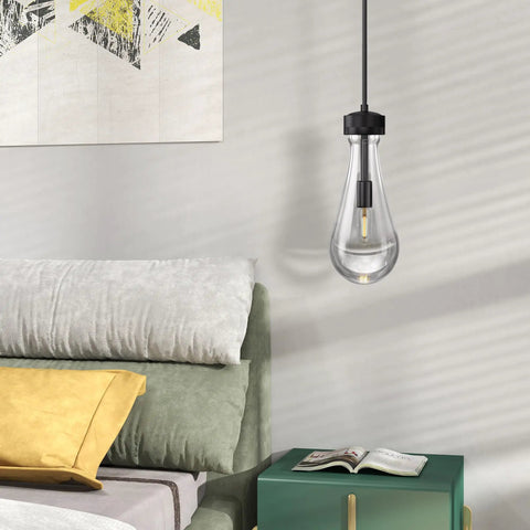 Modern light bulb pendant lamp over a bed with colorful pillows in a stylish bedroom with abstract artwork on the wall.