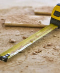 Tape Measure With Blade Armor Built Tough 8 M Metric, Shock Resistant, Mylar Coating, on dusty work site floor