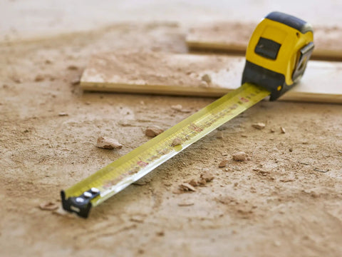 Tape Measure With Blade Armor Built Tough 8 M Metric, Shock Resistant, Mylar Coating, on dusty work site floor
