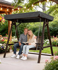Couple sitting on 4 Ft Porch Swing With Stand Heavy Duty 660 Pound Wooden Swing Set With Canopy For Garden Patio And Yard Rustic Outdoor
