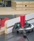 Woodworking jig with miter gauge and red handle on table saw for precise cutting