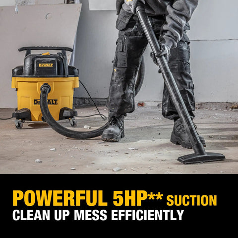 Person using 9 Gallon Wet Dry Shop Vacuum With 5 Peak HP Motor, Poly Can, Rubberized Casters, 10 Foot Cord, And 3 In 1 Multi Function on construction debris