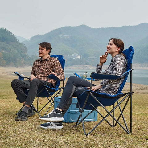 Two Pack Oversized Folding Camping Chair Set With High Back Padded Comfort Grab And Go Style Lightweight Steel Frame Portable Lawn Chairs For Outdoor Use Easy Fold Sturdy And Durable For Adults Grey in use by couple by a lakeside.