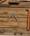 Stainless Steel Eyeglasses Repair Tool With Angled Pliers For Adjusting Frames on wooden surface