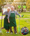 Elderly couple in green aprons holding a TaskStar 21V Battery Powered Weed Puller Tool with rake, in a garden.