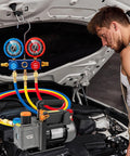 Mechanic using Pro Grade HVAC Vacuum Pump And Gauge Kit With 4.5 CFM Single Stage Pump For Mini Splits And Auto Systems under car hood