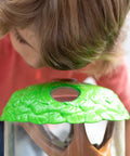 Child examining a ladybug garden kit with live ladybugs, terrarium habitat for kids and toddlers, hands on bug catching set.
