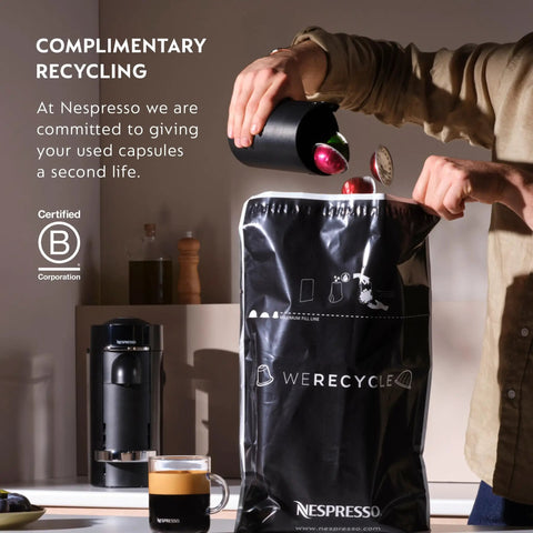 Person recycling capsules next to Vertuo Plus Coffee And Espresso Maker By Breville Grey One Button Brew For Coffee Or Espresso No Fuss Easy Button Brew 25 Second Heat Up And Energy Saving Auto Shut Off Delivers Rich Flavor At Home. Recycling bag in focus.